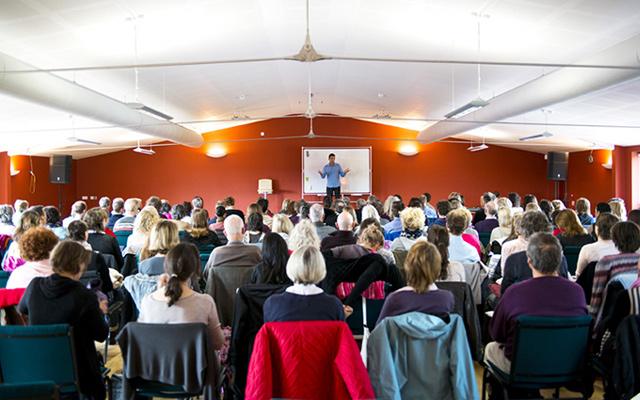 Serge Benhayon on stage at the Universal Medicine UK Retreat 2013